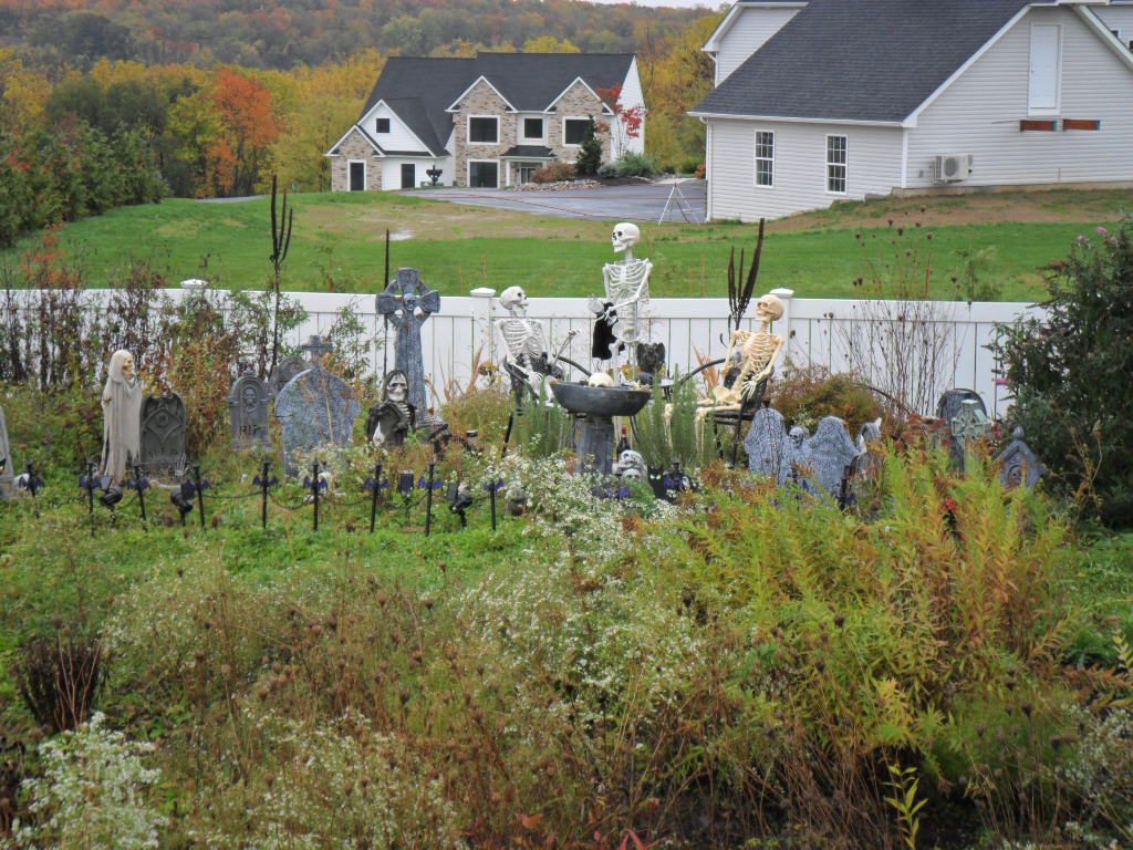 Mourners at cemetery on Halloween