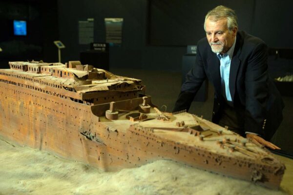 Paul-Henri Nargeolet with a model of the original Titanic where it rests on the ocean floor
